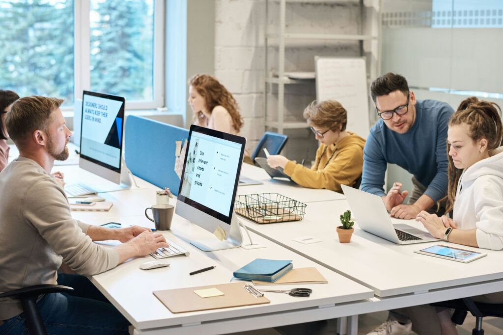 A team of private equity advisors collaborate together at an office table.