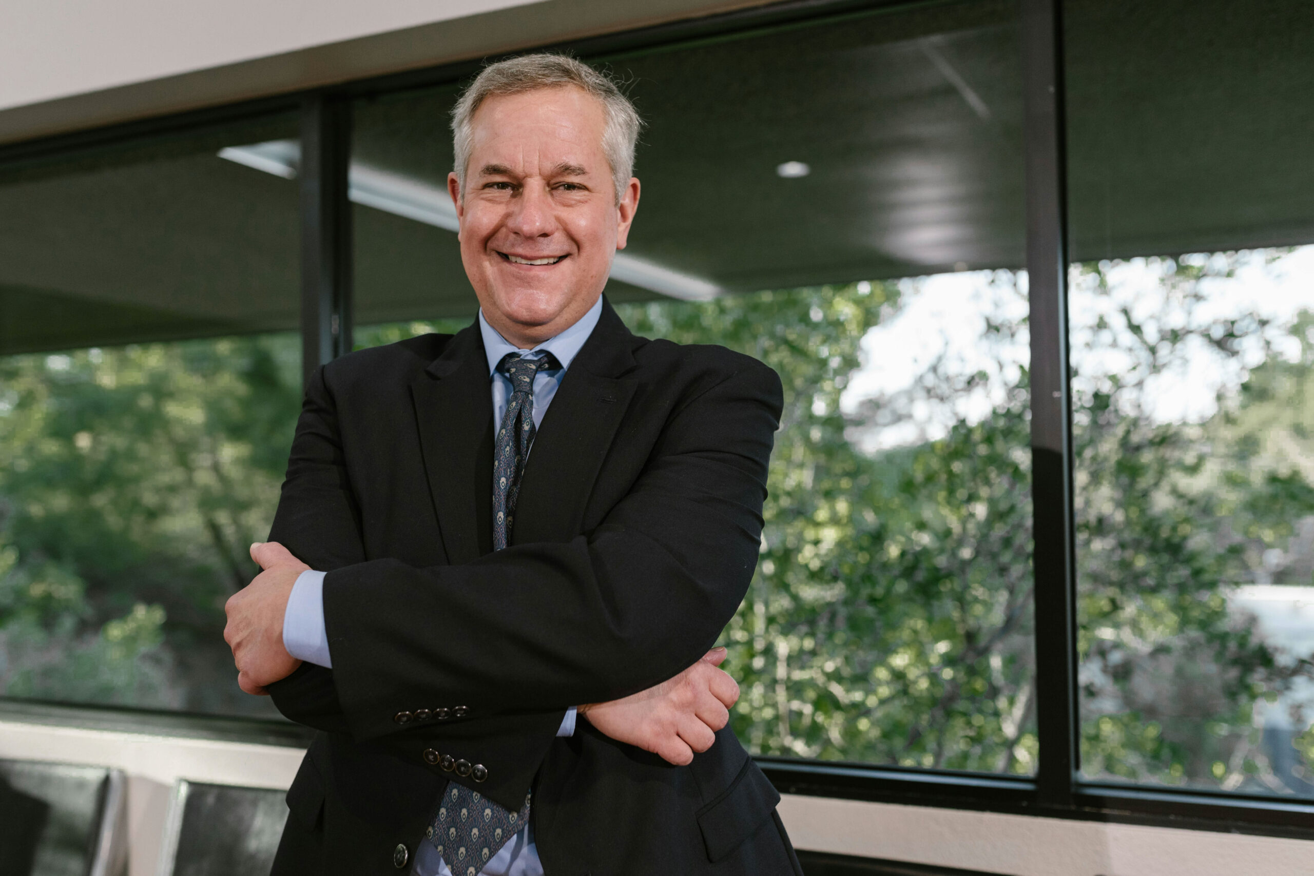 An experienced leader from the expert networks space smiles in a board room.