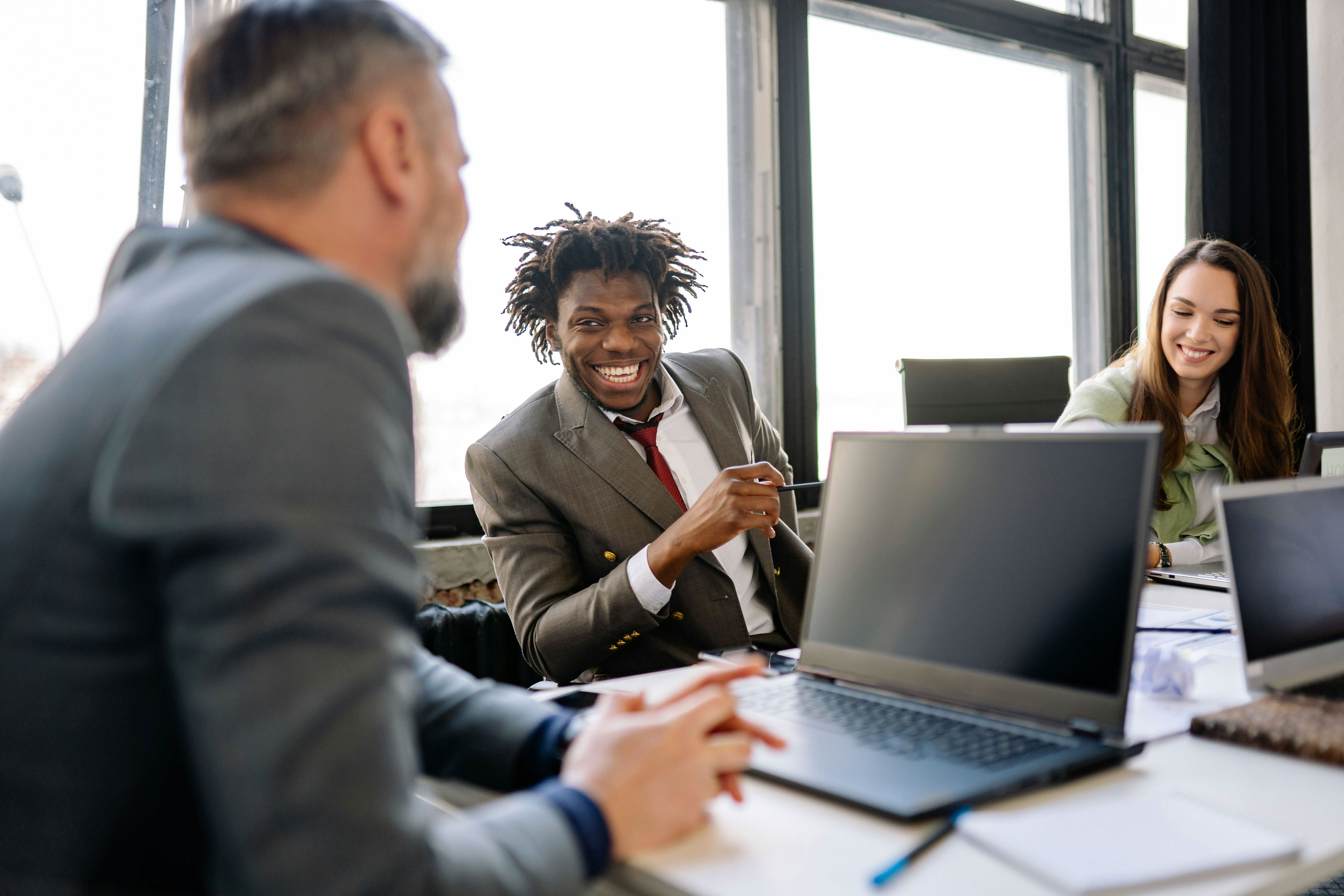 A group of professionals from expert networks work with a client around a work table.