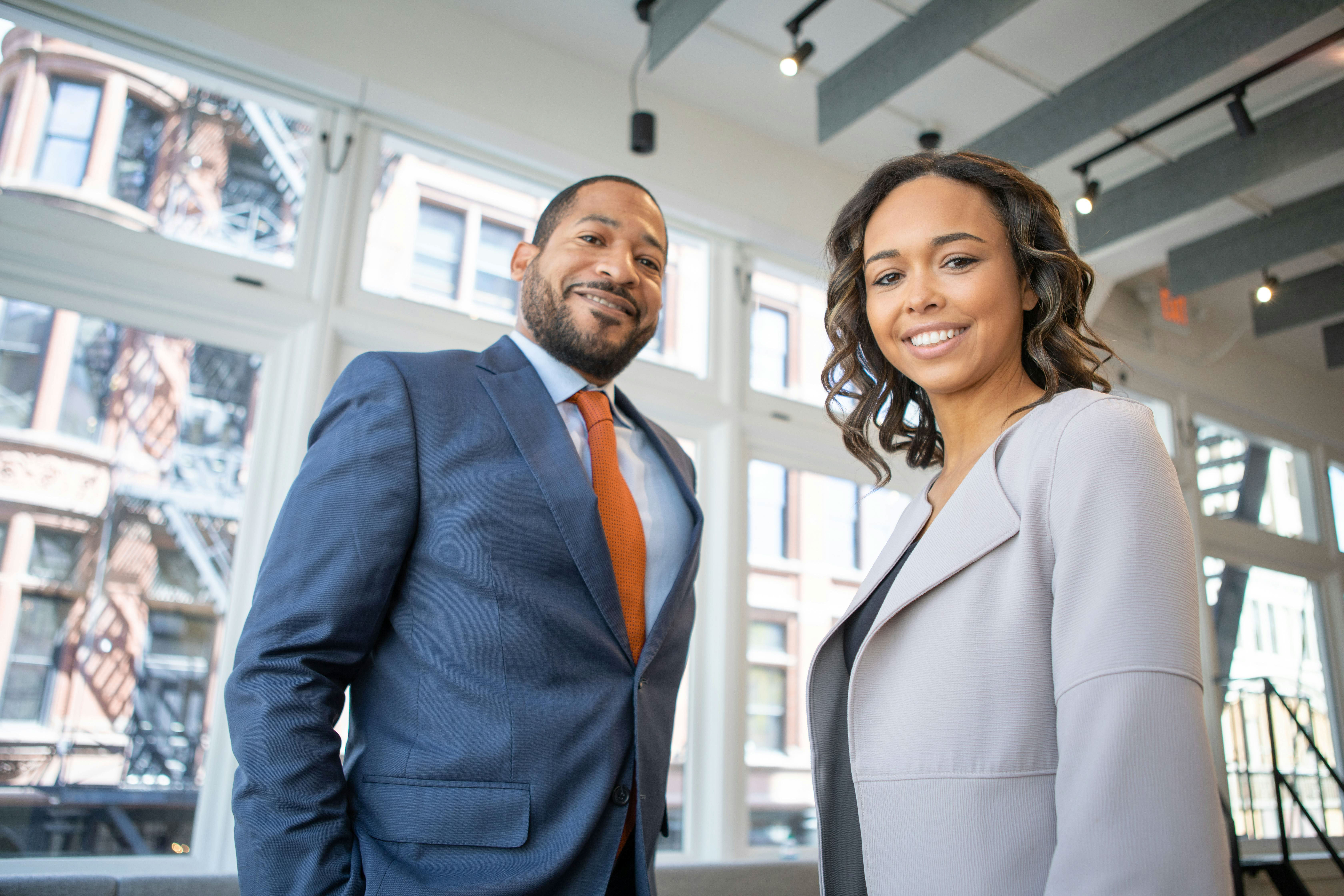 Two young professionals from expert networks smile. 