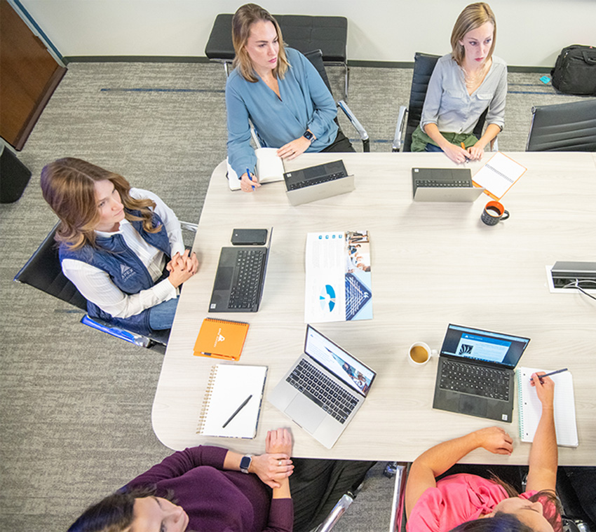 Overhead view of Apex Leaders team meeting, showcasing the collaborative environment of a company providing private equity consulting services.