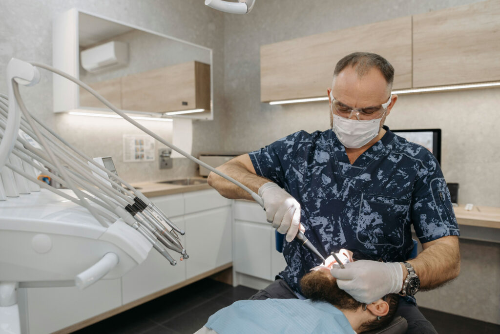 A dentist providing care to a patient hopes to learn more about private equity investment thesis.