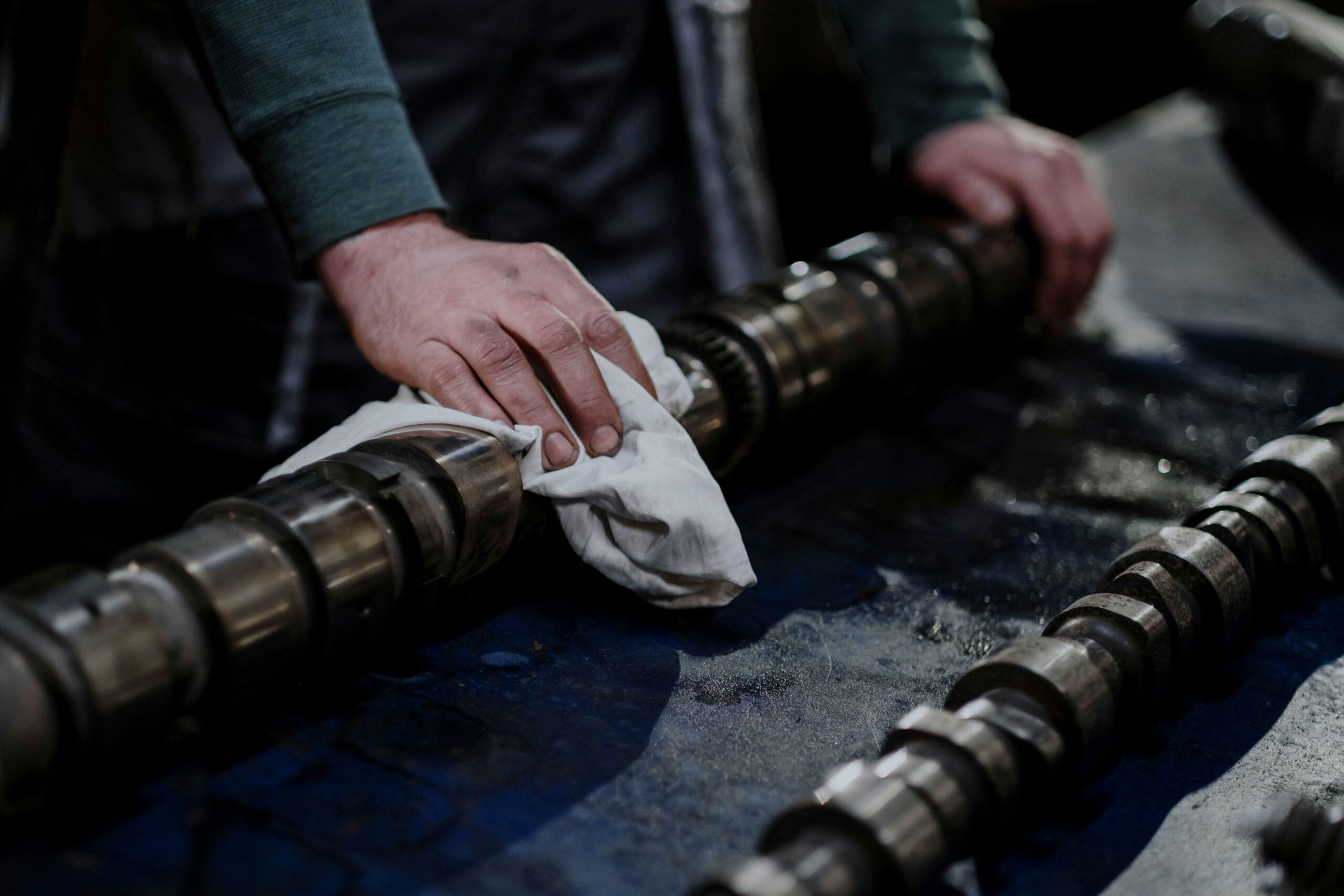 A worker cleans EOL manufactured parts.