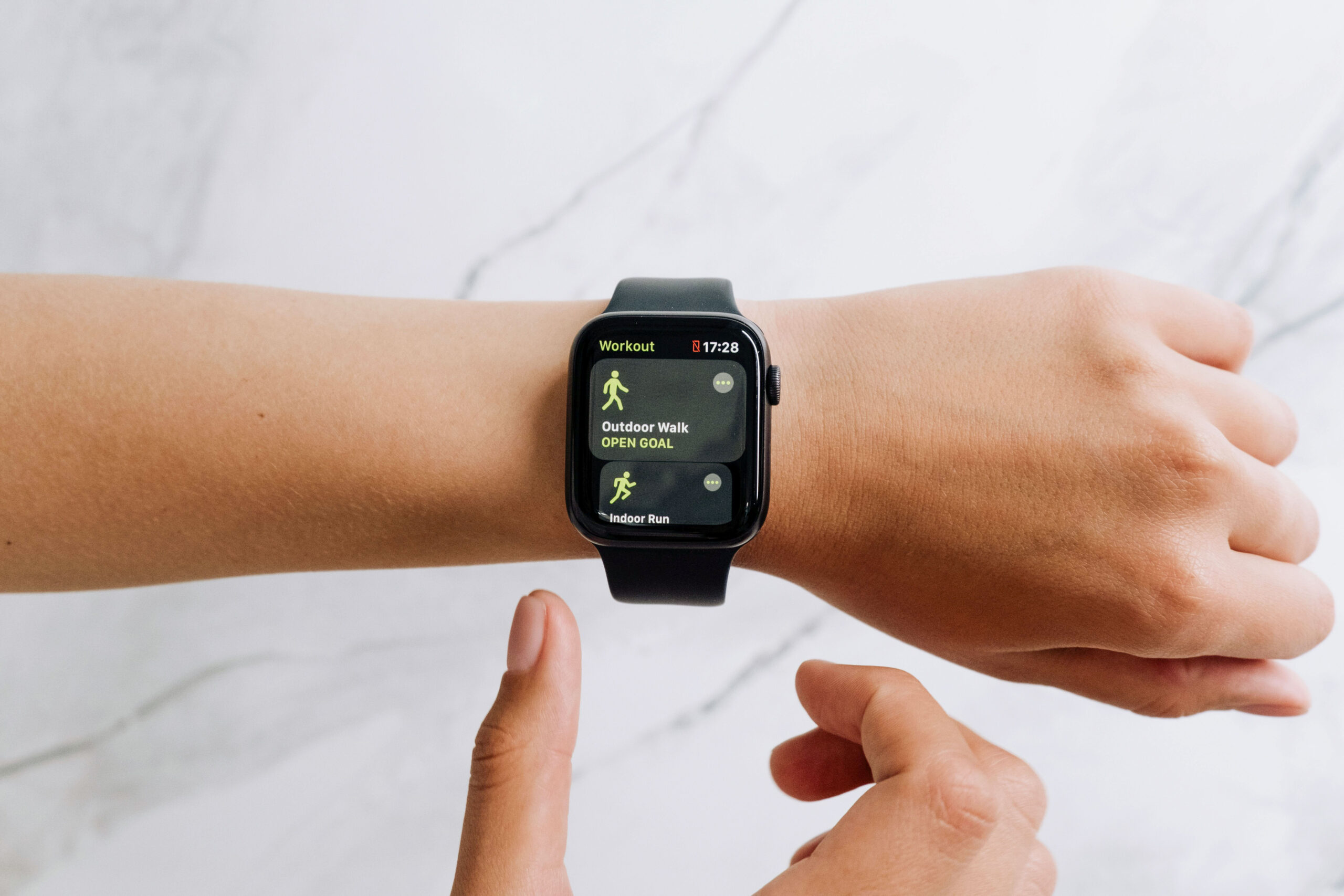 A person wears a fitness watch to track their physical activity—a growing opportunity for private equity healthcare investments.