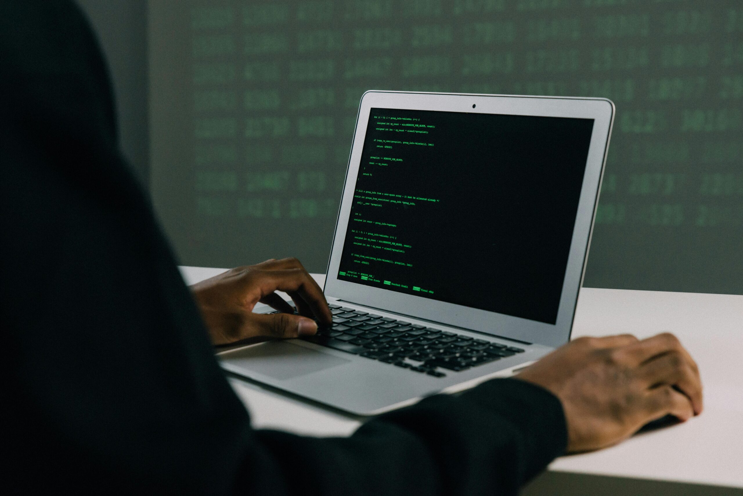 A cybersecurity professional with a laptop open researching dark web investment strategies.