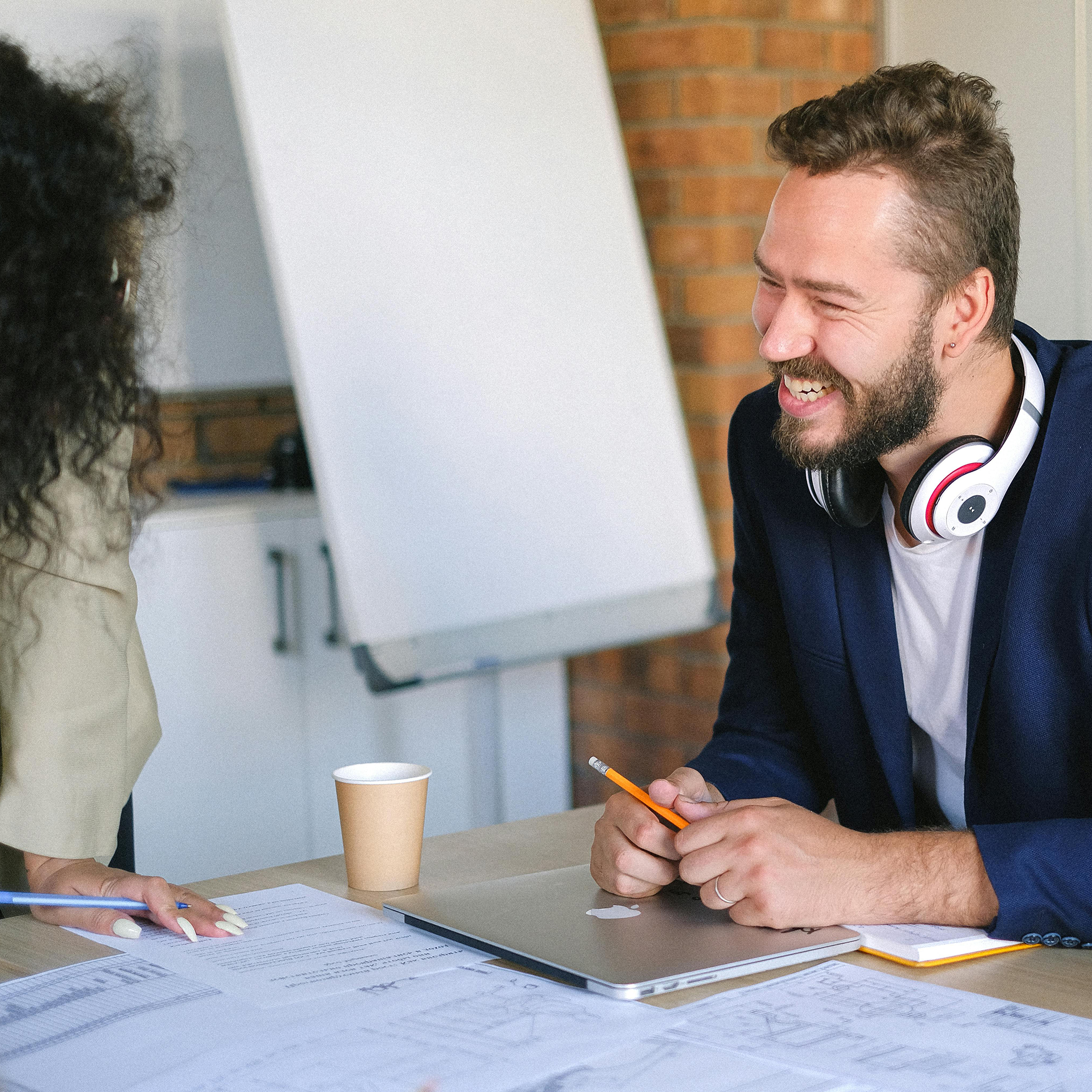 A happy business professional working with an Apex Leaders advisor.