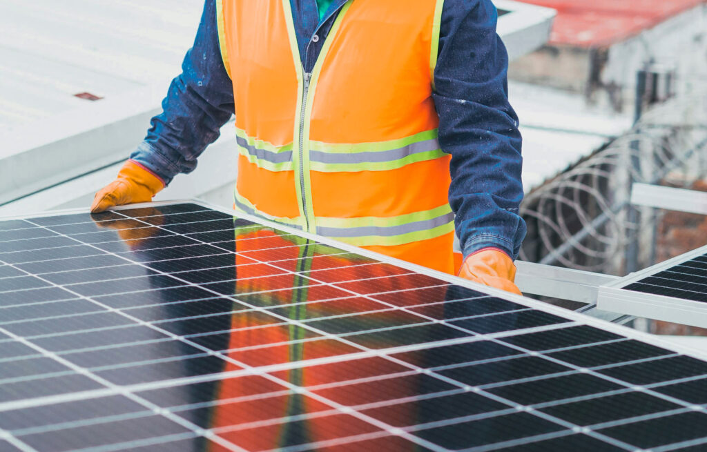 An industry expert aligns new solar panels for a renewable energy investment project.