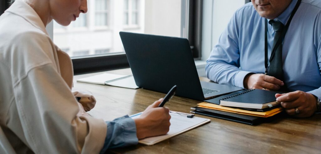 PE firm executives meeting at a conference table discussing vetting board members for their firm.