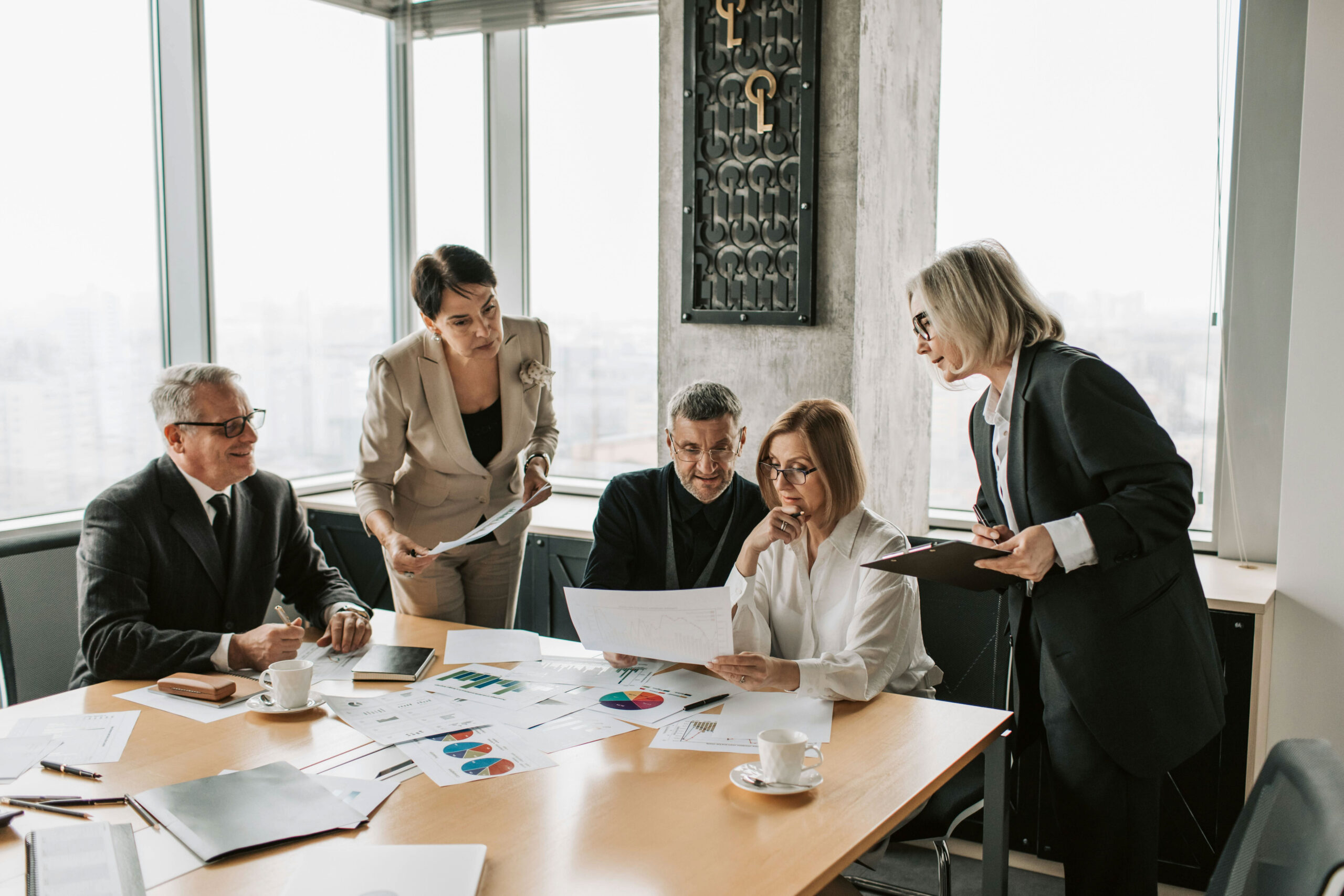 A team formed by traditional expert network firms works together around a table.
