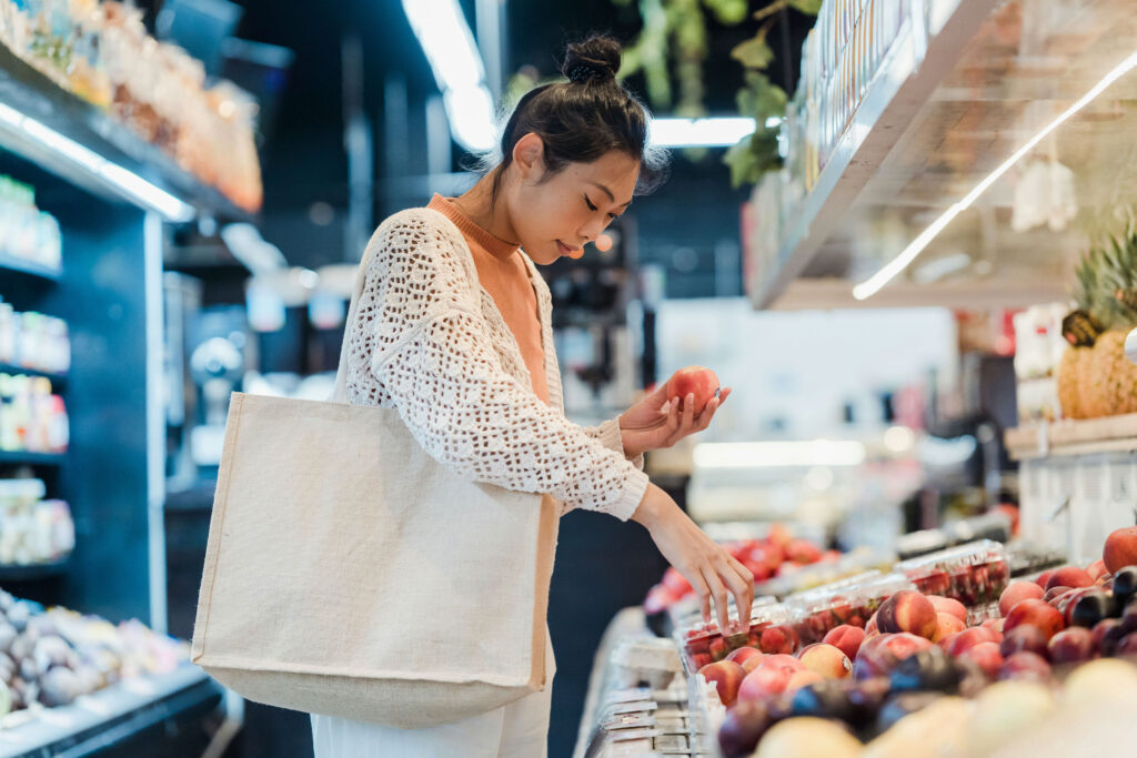 A consumer selects the best food ingredients from a grocery store.