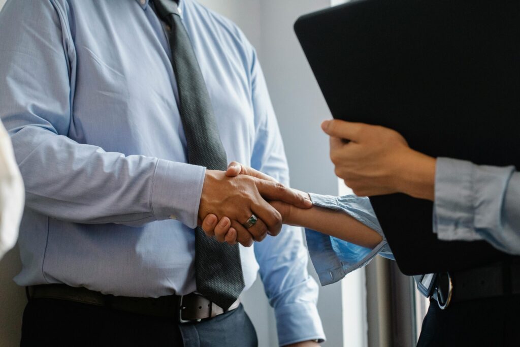 Two private equity executives shake hand on private equity deal